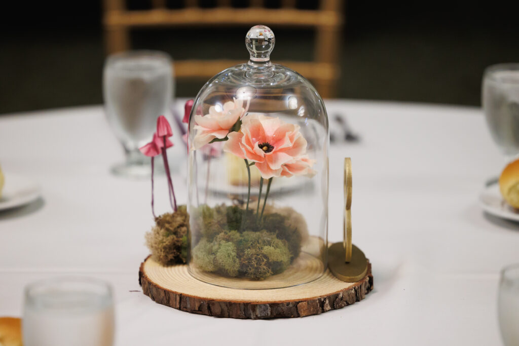 Paper flower table centerpiece with butterfly ranunculus and mushrooms