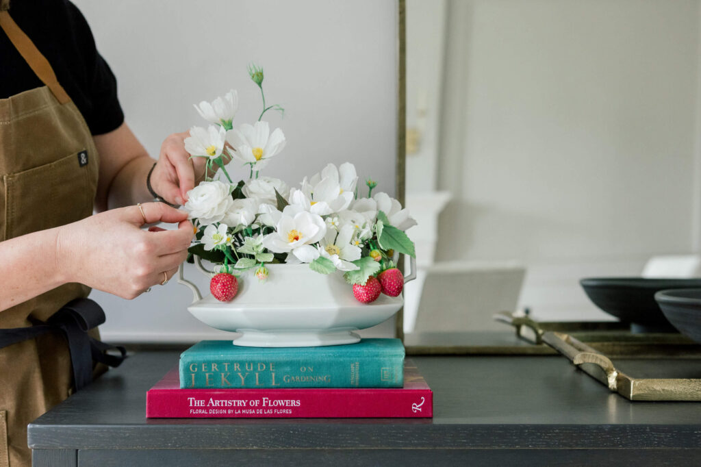 Jenn arranges a few petals of her Strawberries and Cream paper sculpture.